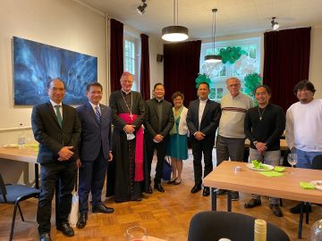 with the ambassador, the priests and members of the organizing team